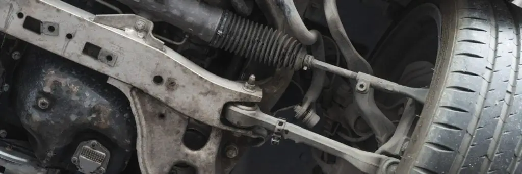 Close-up view of a cars suspension system, showcasing the details of various metal components and the wheel. The image highlights the mechanical intricacies and rugged appearance of the automotive parts. Superior Tire: Tire Shop and Auto Repair Near Me | Barrie | Danforth | Downsview | Markham | Mississauga | Oak Ridges | Scarborough | Thornhill | Toronto | https://superiortire.ca/