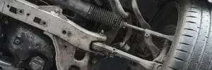 Close-up view of a cars suspension system, showcasing the details of various metal components and the wheel. The image highlights the mechanical intricacies and rugged appearance of the automotive parts. Superior Tire: Tire Shop and Auto Repair Near Me | Barrie | Danforth | Downsview | Markham | Mississauga | Oak Ridges | Scarborough | Thornhill | Toronto | https://superiortire.ca/