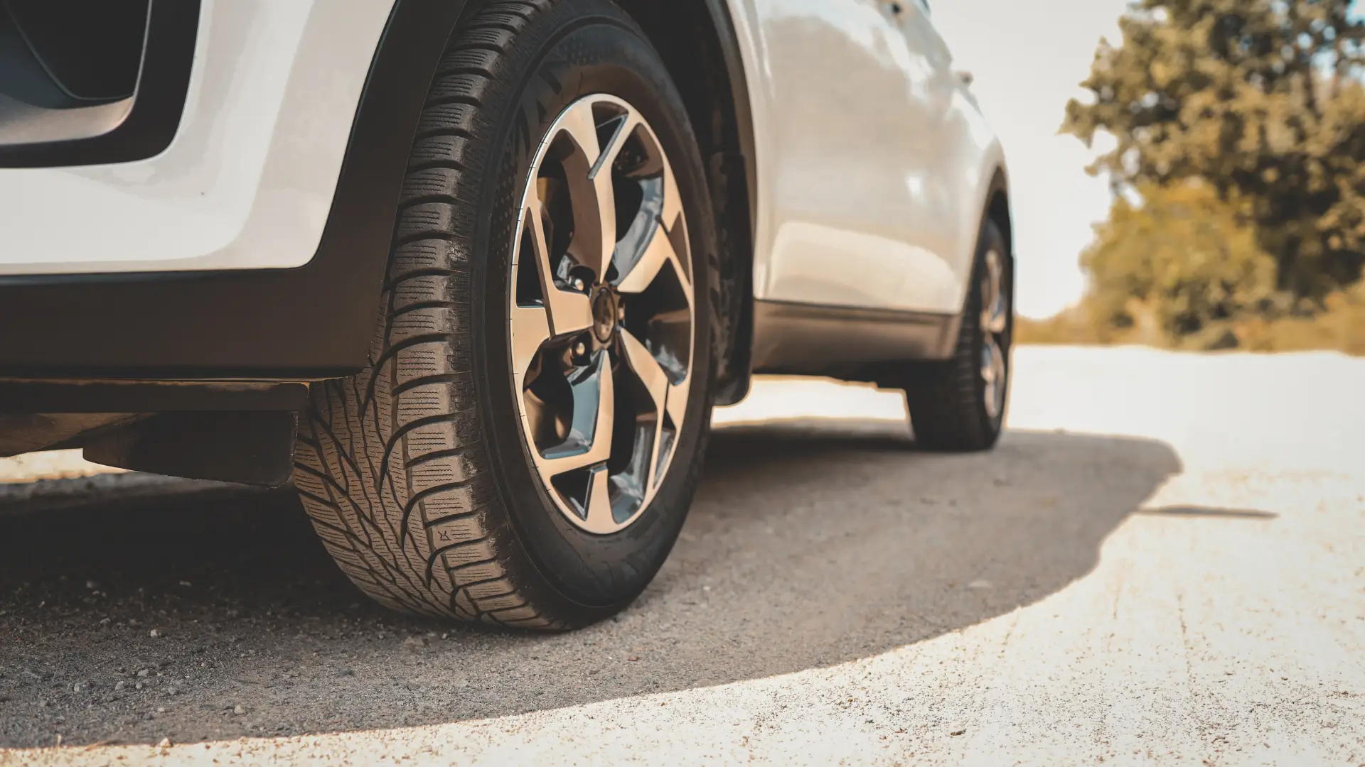 Replace two tires or all four? Technician measuring tire tread depth before replacement